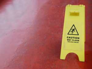 yellow caution sign regarding wet floor that was cleaned by a commercial cleaning service