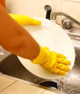washing dishes as part of a winter deep clean