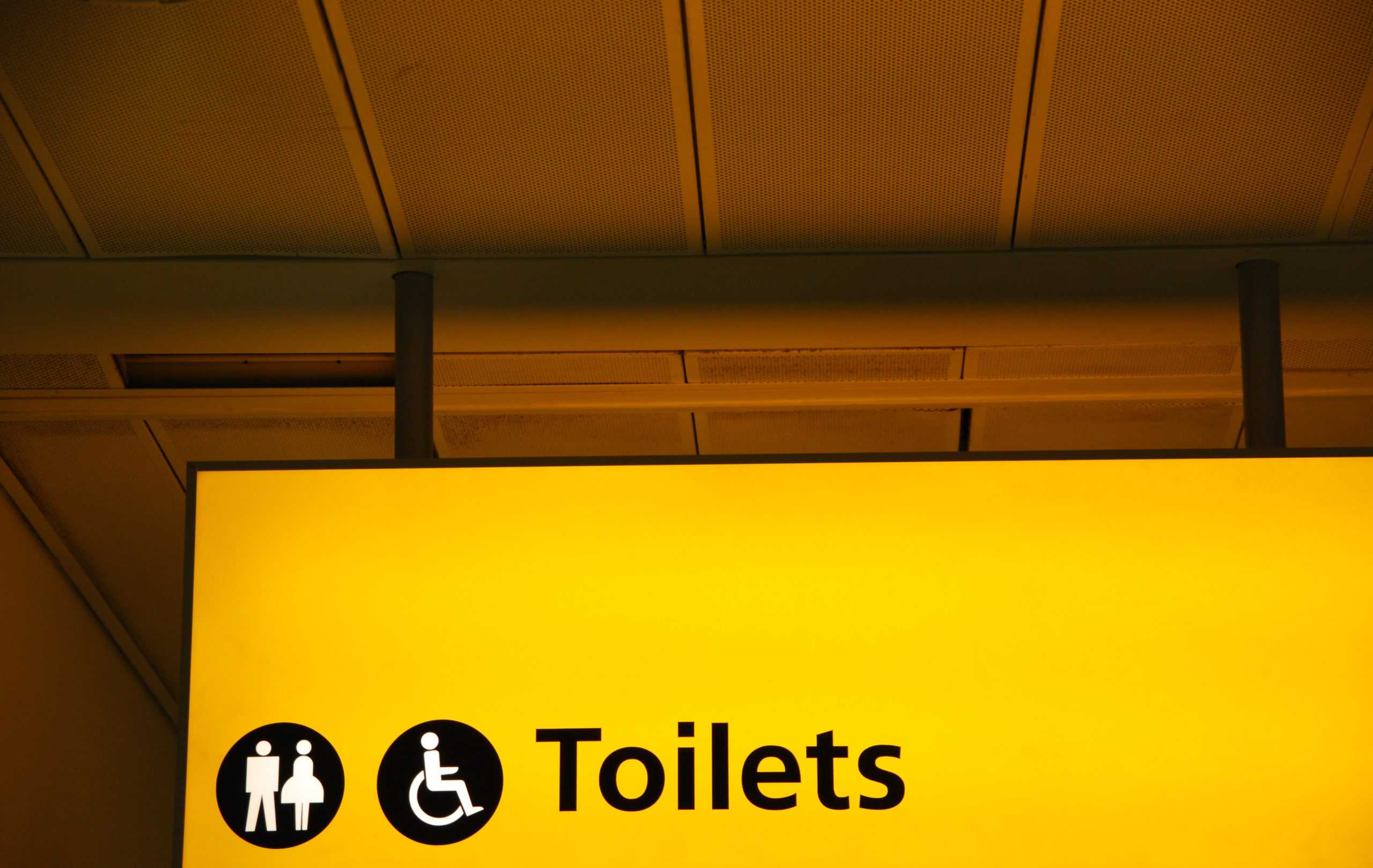 restroom signs pointing to bathroom where cleaners used restroom cleaning checklist