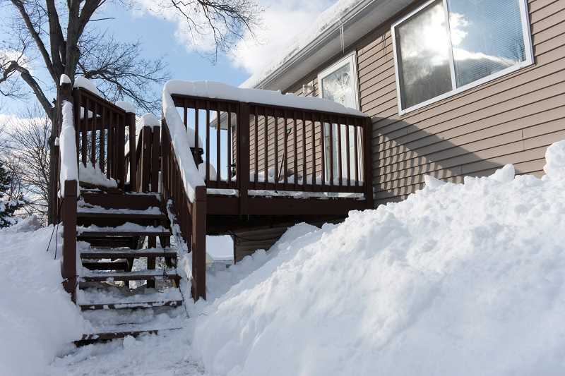 snow covered backyard where snow is tracked in and makes floors dirty