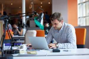 office worker working at computer after office spring cleaning