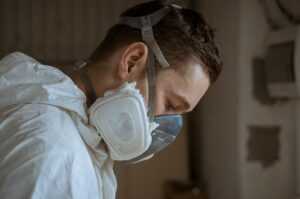 Professional inspecting mold damage in a home