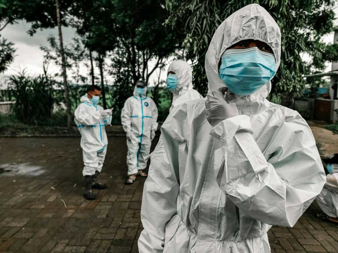 biohazard cleanup technicians in protective gear preparing containment supplies